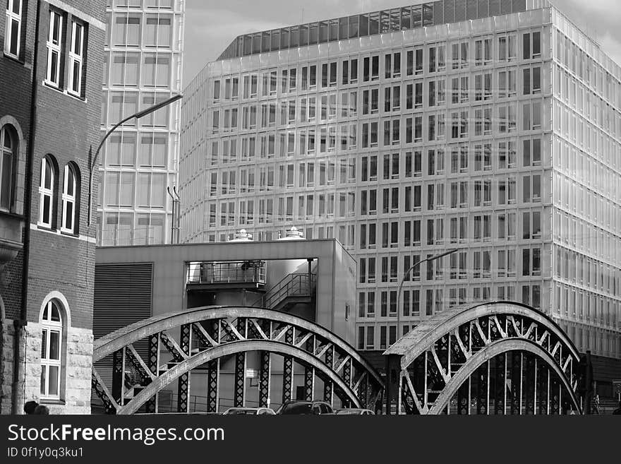 A black and white view of houses and bridge in a city. A black and white view of houses and bridge in a city.