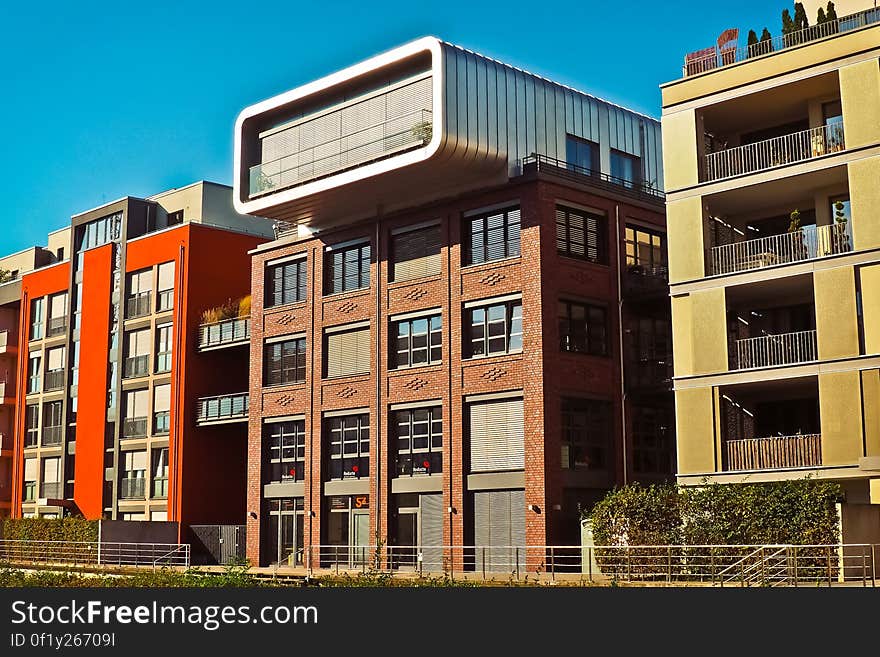 A row of residential buildings with the facades of different color. A row of residential buildings with the facades of different color.