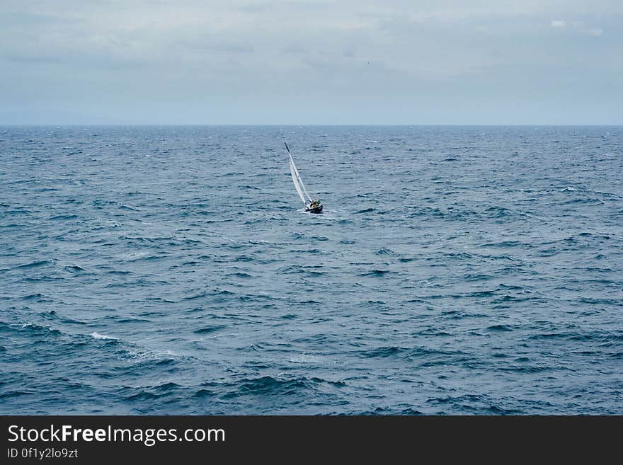 A small sailboat on the sea. A small sailboat on the sea.