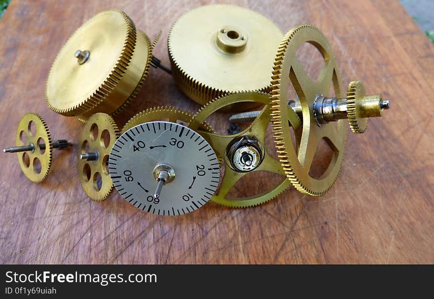 A close up of cogwheels and other pieces of a clock mechanism.