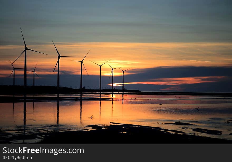 Silhouette Photo of Wind Energys during Golden Hour