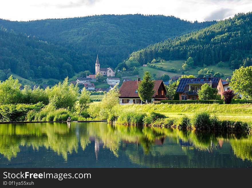 Brown Grey Wooden House Near Lake at Daytime