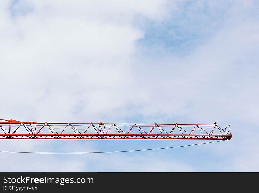 Red Crane Photo Under Cloudy Sky during Daytime