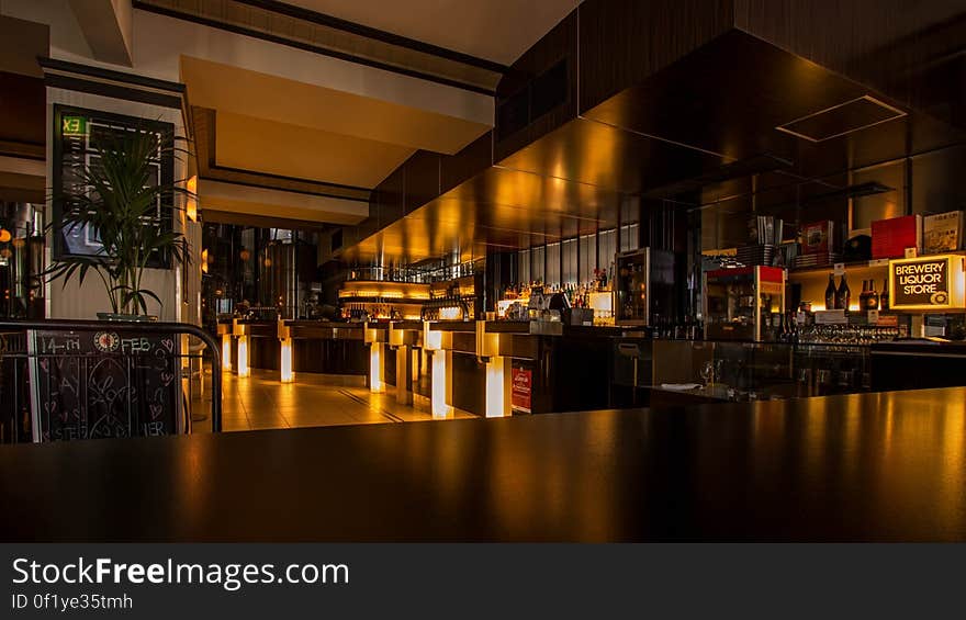 A view inside a restaurant across the bar desk. A view inside a restaurant across the bar desk.