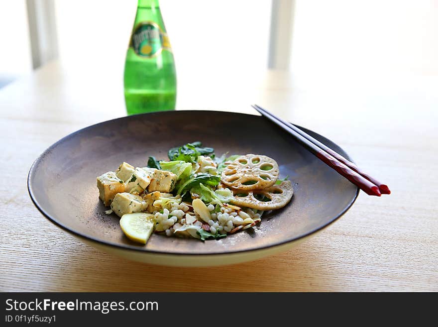 Shabu Shabu on Plate Beside Chopstick and Soda Bottle