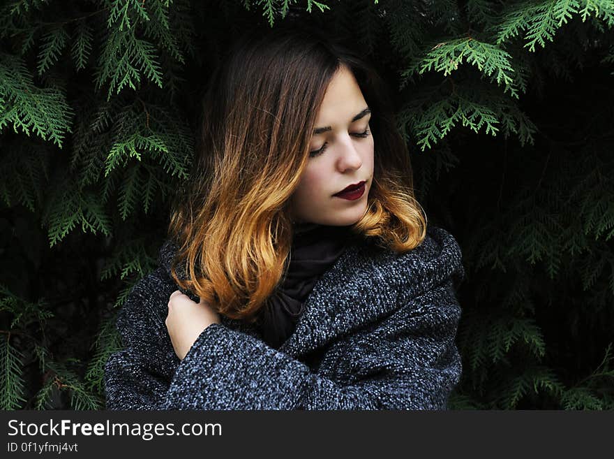 Portrait of Young Woman in Forest during Winter