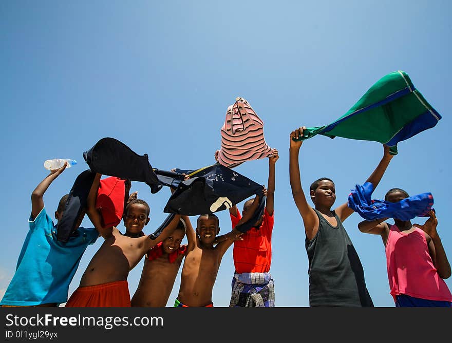 Somali children hold their shirts aloft to dry in the wind at Lido Beach in the Abdul-Aziz district of the Somali capital Mogadishu 09 November 2012. Lido Beach has become a popular spot on Friday&#x27;s with hundreds of Somalis since the withdrawal in August 2011 of the Al-Qaeda affiliated extremist group Al Shabaab who had banned any such social gatherings between men and women. The United Nations Security Council on November 7 renewed the mandate of the African Union Mission in Somalia &#x28;AMISOM&#x29; peacekeeping force for a further four months to continue providing support to the Government of Somalia in its efforts to bring peace and stability to the Horn of African country. AU-UN IST PHOTO / STUART PRICE. Somali children hold their shirts aloft to dry in the wind at Lido Beach in the Abdul-Aziz district of the Somali capital Mogadishu 09 November 2012. Lido Beach has become a popular spot on Friday&#x27;s with hundreds of Somalis since the withdrawal in August 2011 of the Al-Qaeda affiliated extremist group Al Shabaab who had banned any such social gatherings between men and women. The United Nations Security Council on November 7 renewed the mandate of the African Union Mission in Somalia &#x28;AMISOM&#x29; peacekeeping force for a further four months to continue providing support to the Government of Somalia in its efforts to bring peace and stability to the Horn of African country. AU-UN IST PHOTO / STUART PRICE.