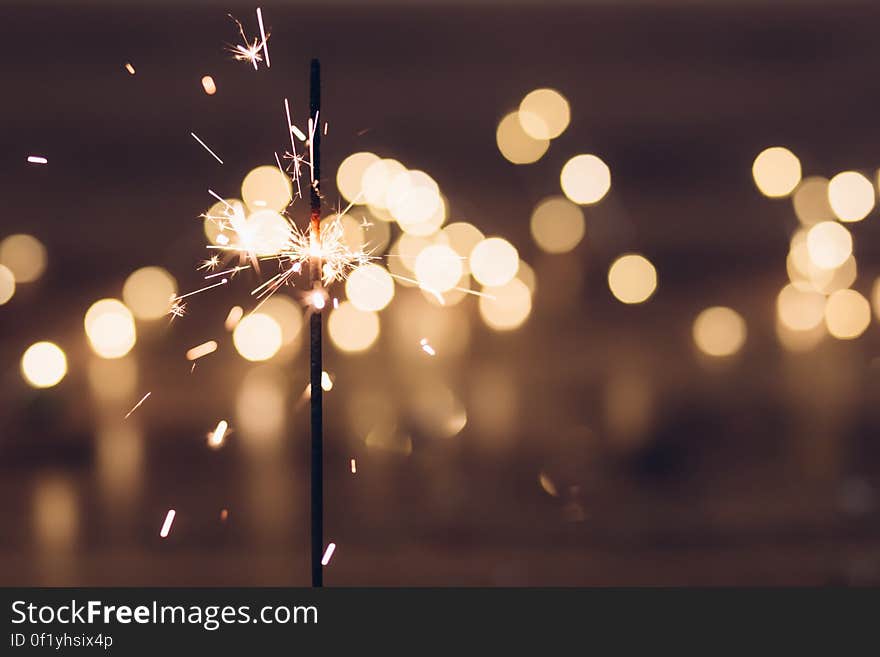 A burning sparkler with a defocused bokeh background. A burning sparkler with a defocused bokeh background.