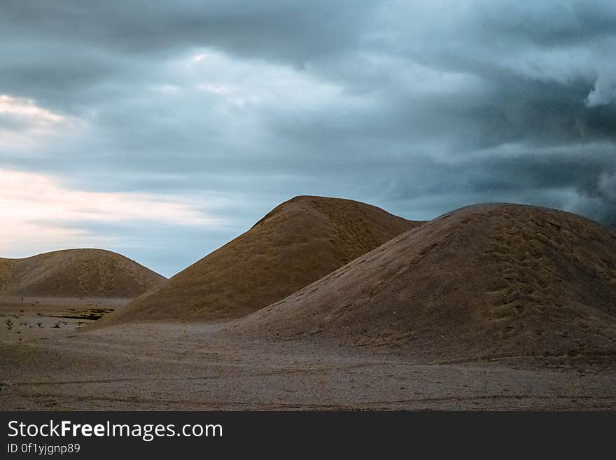 A view across a desert with sand dunes.