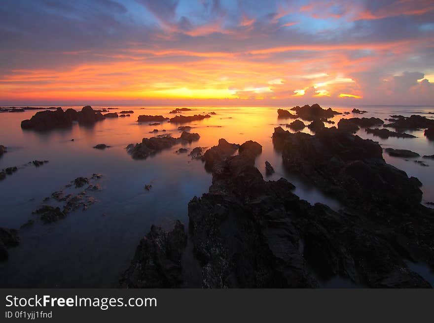 A rocky beach at sunset. A rocky beach at sunset.