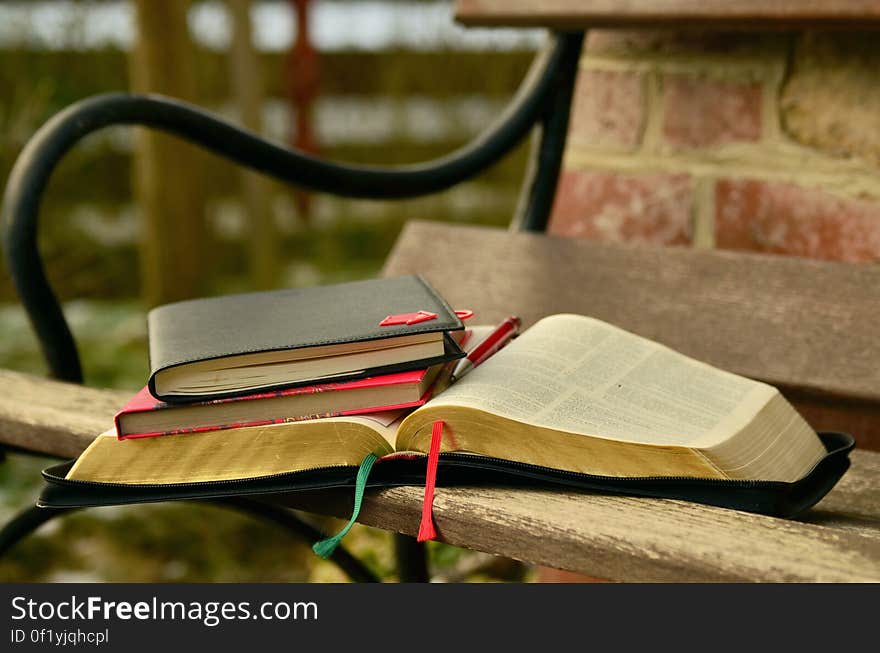 Black Open Book on the Brown Wooden Bench