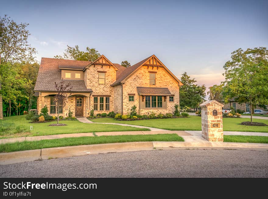 An elegant old fashioned countryside house with a lawn. An elegant old fashioned countryside house with a lawn.