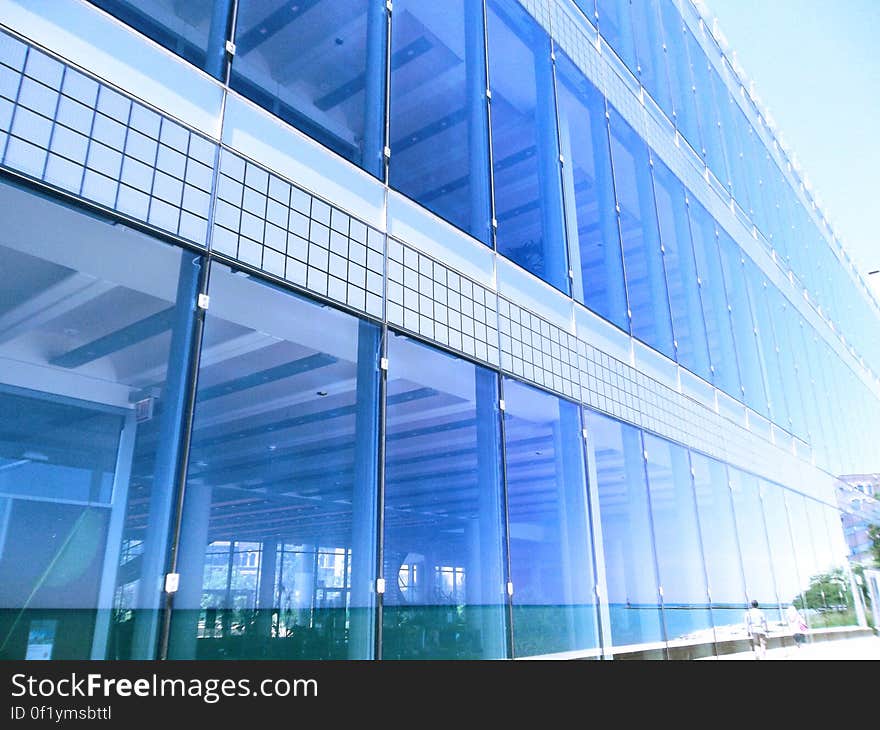 The facade of a modern building with large glass windows.