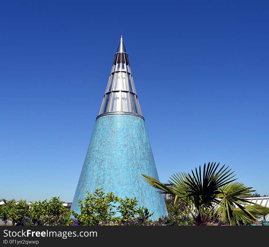 A blue conical building with a metallic tip. A blue conical building with a metallic tip.