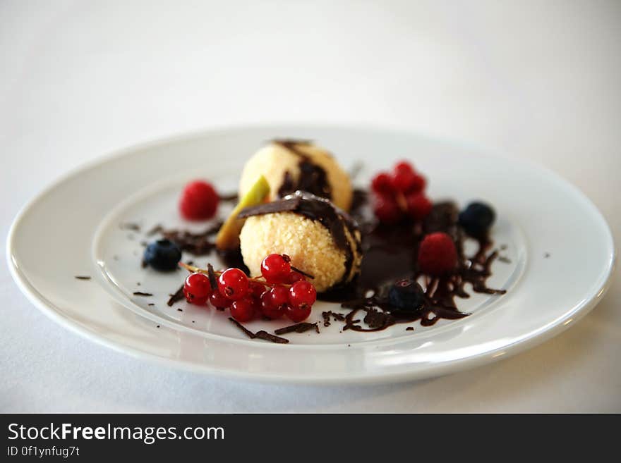 A dessert with chocolate and red currants. A dessert with chocolate and red currants.