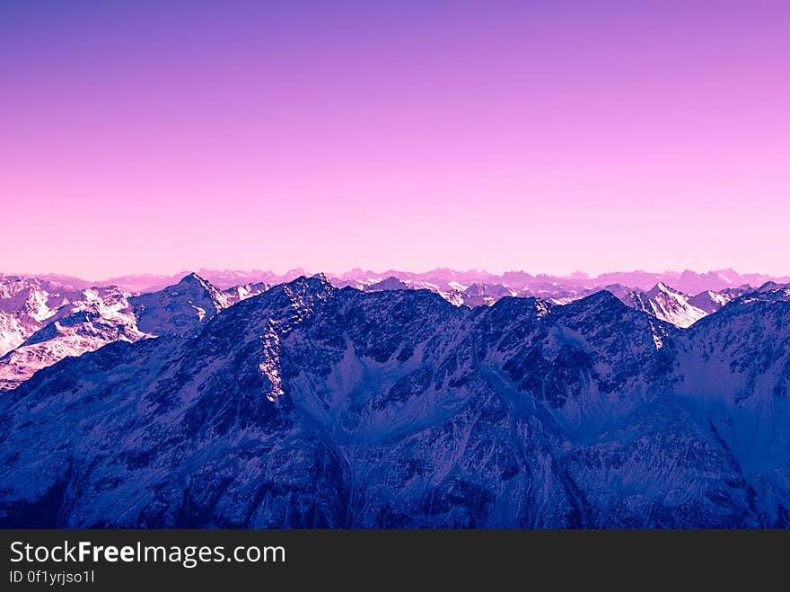 A mountain range with false color skies.