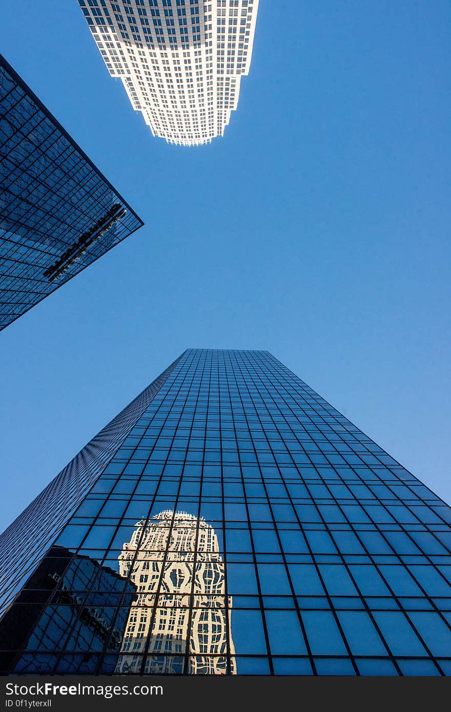 A trio of skyscrapers against blue sky.