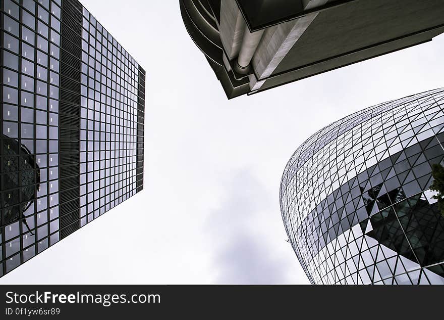 Worm&#x27;s Eye View of Mirror Covered Concrete Buildings Under Gray Cloudy Skies