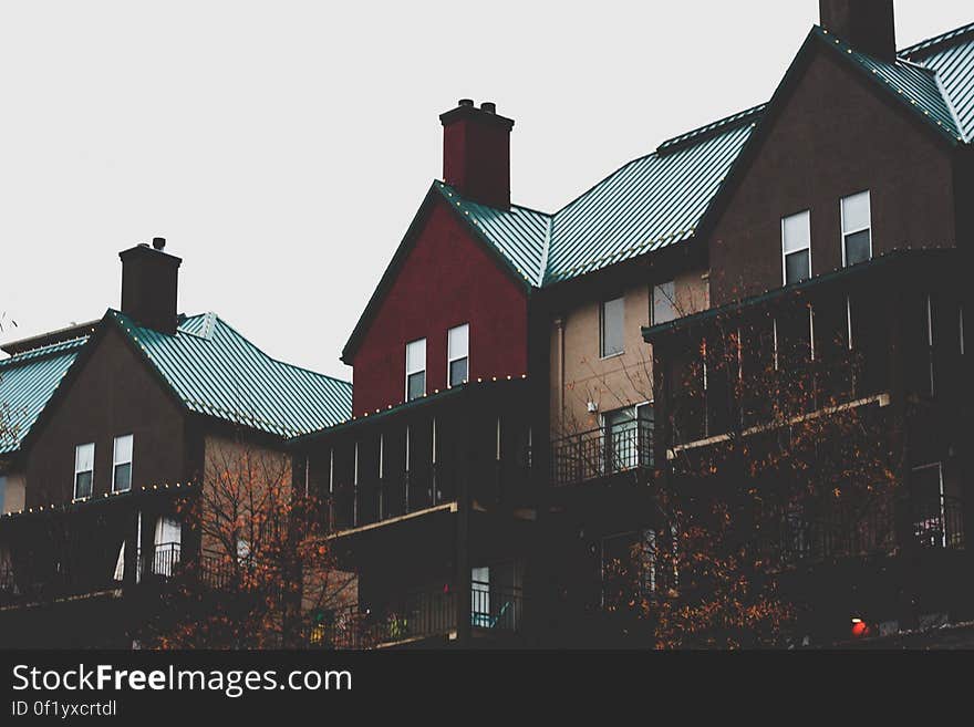 A group of older style apartment buildings in city. A group of older style apartment buildings in city.