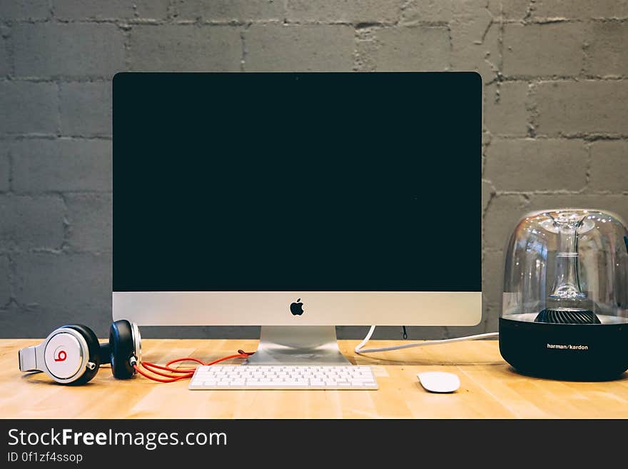 A workstation with a computer, sound system and headphones. A workstation with a computer, sound system and headphones.