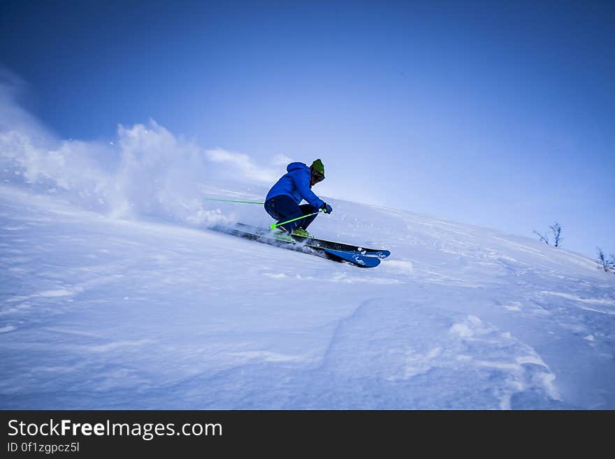 A skier on a slope with deep snow. A skier on a slope with deep snow.