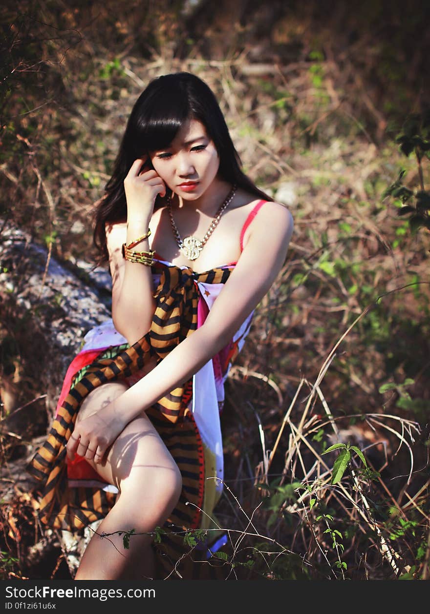 Woman in Pink White and Black Sleeveless Dress Posing for Photo