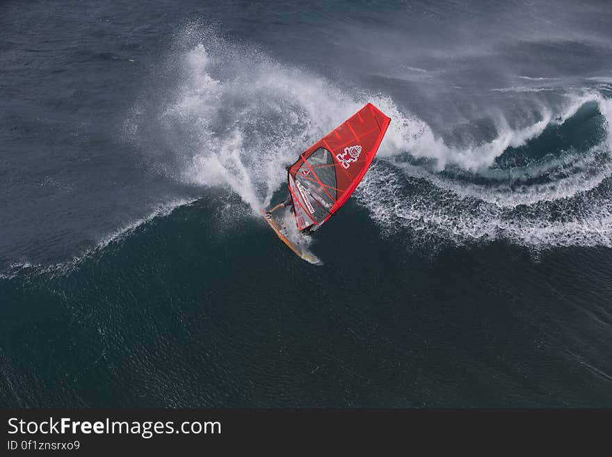 Person in Surfboard in the Wave during Daytime