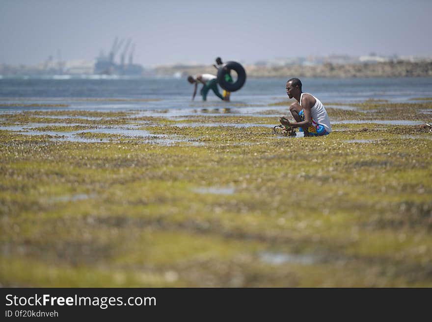 A man searches for disgarded objects on a sand bank off of Lido beach in the Somali capital of Mogadishu on January 31. The Mogadishu lifeguards, consisting entirely of a volunteer force of fisherman, began patrolling Lido beach in September 2013 after a spate of drownings. Mogadishu&#x27;s beaches have become a popular destination for the city&#x27;s residents since al Shabab withdrew the majority of its militants from the city in 2011. AU UN IST PHOTO / Tobin Jones. A man searches for disgarded objects on a sand bank off of Lido beach in the Somali capital of Mogadishu on January 31. The Mogadishu lifeguards, consisting entirely of a volunteer force of fisherman, began patrolling Lido beach in September 2013 after a spate of drownings. Mogadishu&#x27;s beaches have become a popular destination for the city&#x27;s residents since al Shabab withdrew the majority of its militants from the city in 2011. AU UN IST PHOTO / Tobin Jones