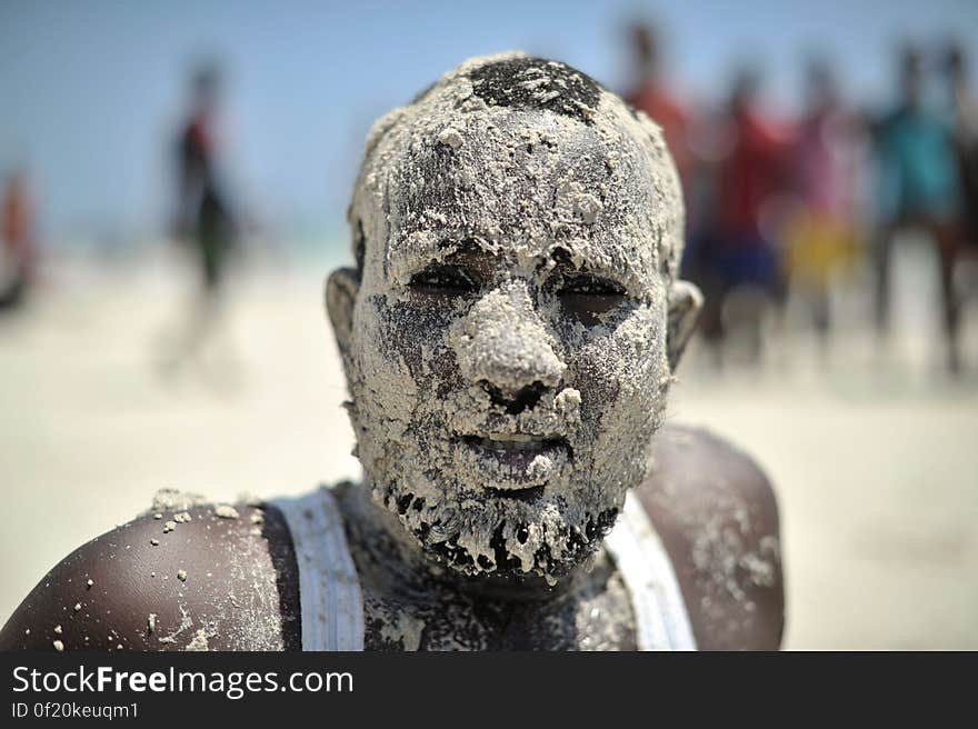 A Somali man, his face covered in sand, enjoys a day out at Lido beach in Mogadishu, Somalia, on January 31. The Mogadishu lifeguards, consisting entirely of a volunteer force of fisherman, began patrolling Lido beach in September 2013 after a spate of drownings. Mogadishu&#x27;s beaches have become a popular destination for the city&#x27;s residents since al Shabab withdrew the majority of its militants from the city in 2011. AU UN IST PHOTO / Tobin Jones. A Somali man, his face covered in sand, enjoys a day out at Lido beach in Mogadishu, Somalia, on January 31. The Mogadishu lifeguards, consisting entirely of a volunteer force of fisherman, began patrolling Lido beach in September 2013 after a spate of drownings. Mogadishu&#x27;s beaches have become a popular destination for the city&#x27;s residents since al Shabab withdrew the majority of its militants from the city in 2011. AU UN IST PHOTO / Tobin Jones