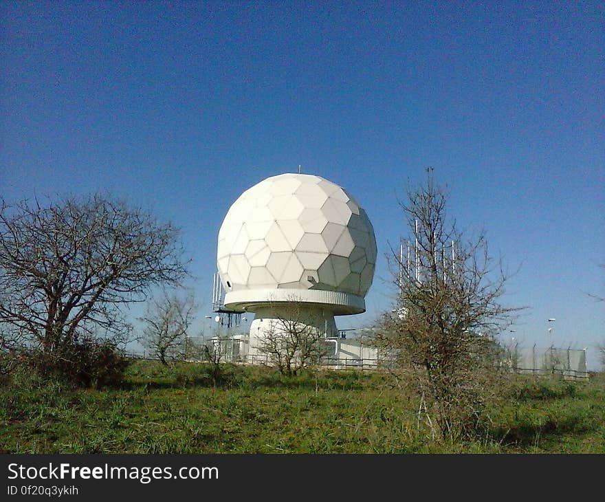 A geodesic dome under blue skies.