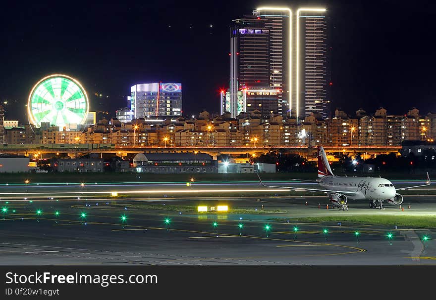 A city on the background of an airport in the night. A city on the background of an airport in the night.