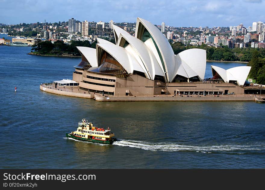 The Sydney Opera House is a multi-venue performing arts centre in Sydney, New South Wales, Australia. Situated on Bennelong Point in Sydney Harbour, close to the Sydney Harbour Bridge, the facility is adjacent to the Sydney central business district and the Royal Botanic Gardens, between Sydney and Farm Coves. Designed by Danish architect Jørn Utzon, the facility formally opened on 20 October 1973 after a gestation beginning with Utzon&#x27;s 1957 selection as winner of an international design competition. The Government of New South Wales, led by the premier, Joseph Cahill, authorised work to begin in 1958 with Utzon directing construction. The government&#x27;s decision to build Utzon&#x27;s design is often overshadowed by circumstances that followed, including cost and scheduling overruns as well as the architect&#x27;s ultimate resignation. The Sydney Opera House is a multi-venue performing arts centre in Sydney, New South Wales, Australia. Situated on Bennelong Point in Sydney Harbour, close to the Sydney Harbour Bridge, the facility is adjacent to the Sydney central business district and the Royal Botanic Gardens, between Sydney and Farm Coves. Designed by Danish architect Jørn Utzon, the facility formally opened on 20 October 1973 after a gestation beginning with Utzon&#x27;s 1957 selection as winner of an international design competition. The Government of New South Wales, led by the premier, Joseph Cahill, authorised work to begin in 1958 with Utzon directing construction. The government&#x27;s decision to build Utzon&#x27;s design is often overshadowed by circumstances that followed, including cost and scheduling overruns as well as the architect&#x27;s ultimate resignation