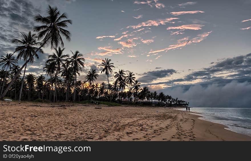 The sun sets over the Dominican Republic while walking on the beach in Bavaro, near Punta Cana. The sun sets over the Dominican Republic while walking on the beach in Bavaro, near Punta Cana.