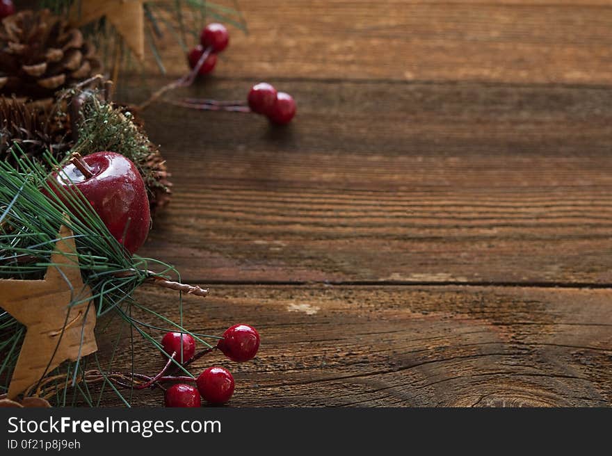 Different Christmas decorations on a wooden background.