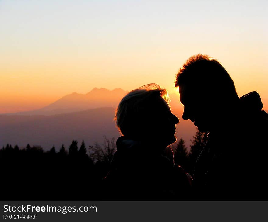 Silhouette Couple Kissing Against Sky during Sunset