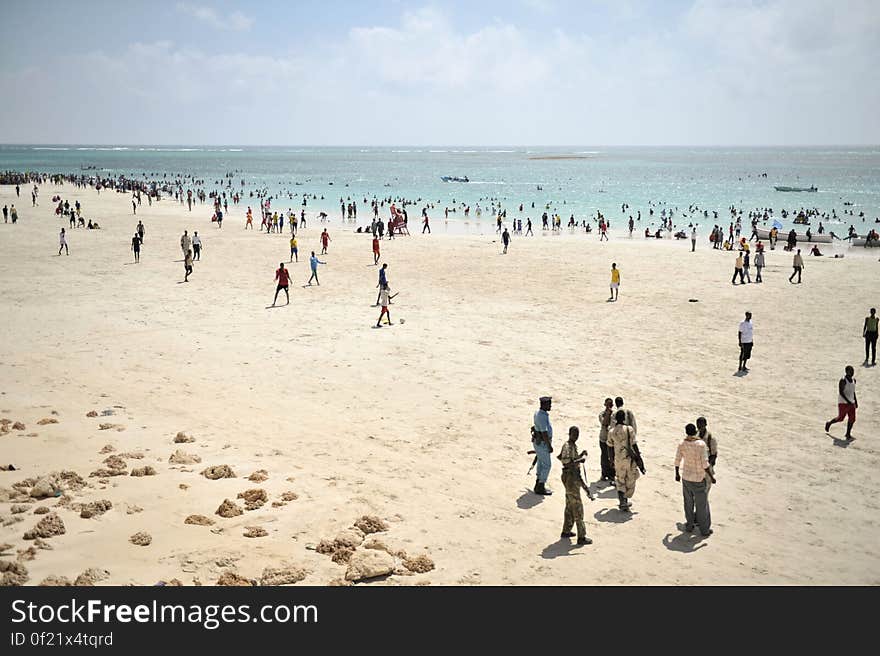 Residents of Mogadishu enjoy Lido beach, while police stand guard outside of a restaurant, on January 31 in Somalia. The Mogadishu lifeguards, consisting entirely of a volunteer force of fisherman, began patrolling Lido beach in September 2013 after a spate of drownings. Mogadishu&#x27;s beaches have become a popular destination for the city&#x27;s residents since al Shabab withdrew the majority of its militants from the city in 2011. AU UN IST PHOTO / Tobin Jones. Residents of Mogadishu enjoy Lido beach, while police stand guard outside of a restaurant, on January 31 in Somalia. The Mogadishu lifeguards, consisting entirely of a volunteer force of fisherman, began patrolling Lido beach in September 2013 after a spate of drownings. Mogadishu&#x27;s beaches have become a popular destination for the city&#x27;s residents since al Shabab withdrew the majority of its militants from the city in 2011. AU UN IST PHOTO / Tobin Jones