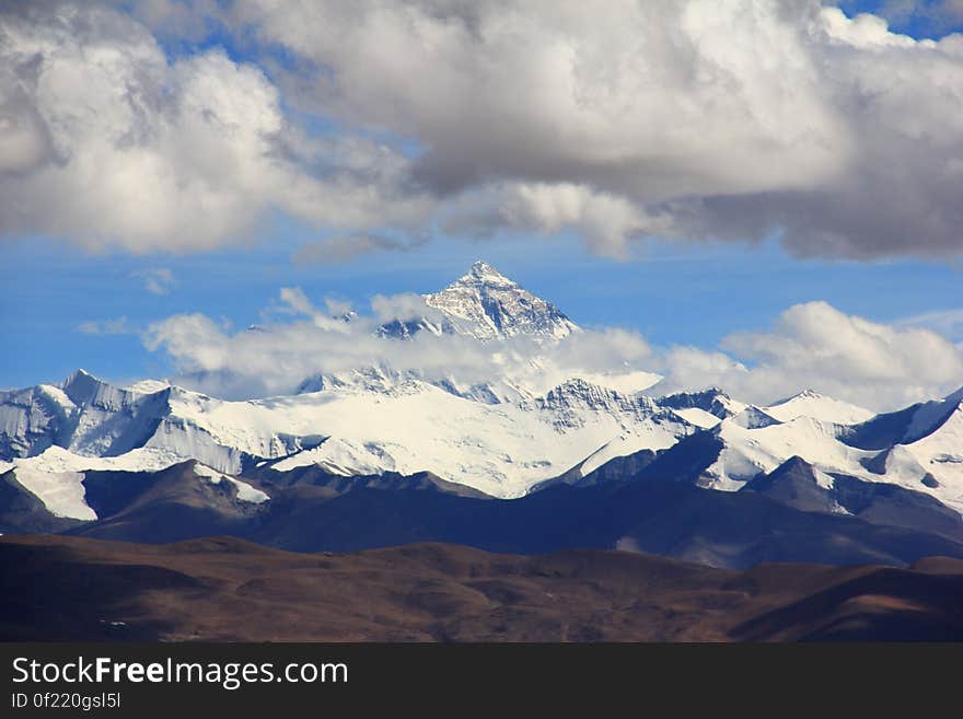 Snow Filled Mountain Under Cloudy Sky during Daytime