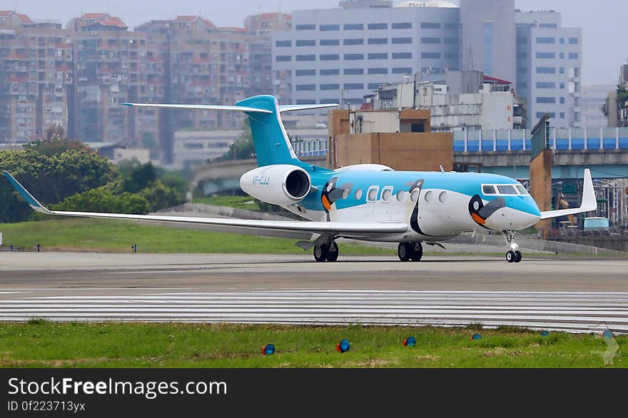 Commercial jet on runway in urban airport.