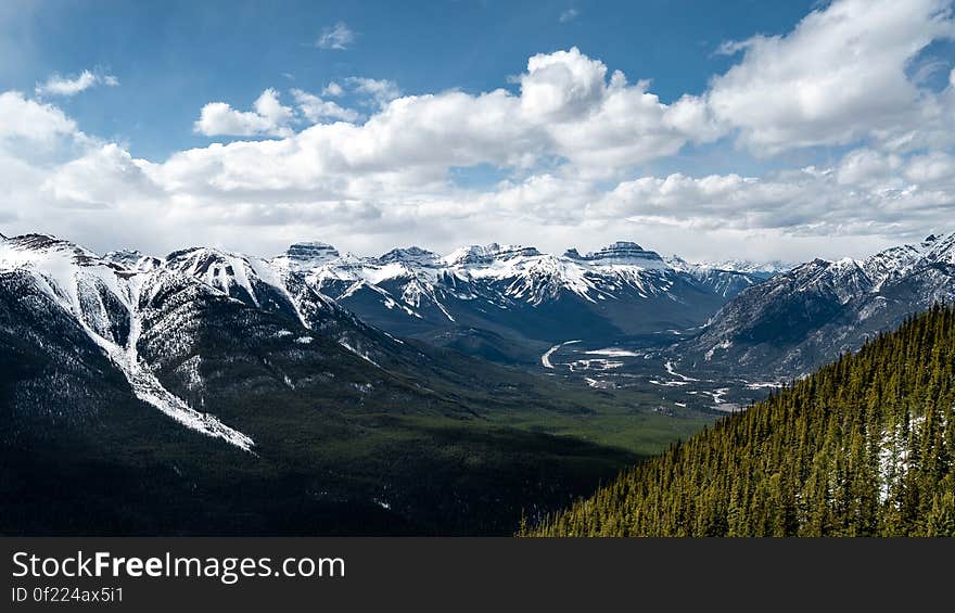 A valley lined with snow capped mountains. A valley lined with snow capped mountains.