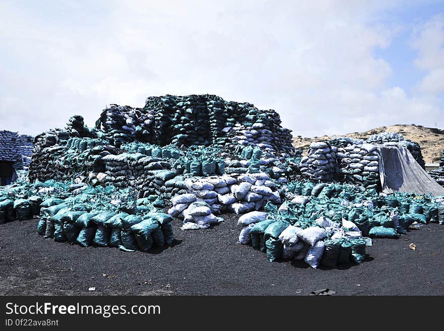 Bags of charcoal lie stockpiled on the edge of Kismayo city. The charcoal trade remains the city&#x27;s largest industry, but its future remains uncertain due to a UN embargo which forbids its export. AU-UN IST PHOTO / TOBIN JONES. Bags of charcoal lie stockpiled on the edge of Kismayo city. The charcoal trade remains the city&#x27;s largest industry, but its future remains uncertain due to a UN embargo which forbids its export. AU-UN IST PHOTO / TOBIN JONES.