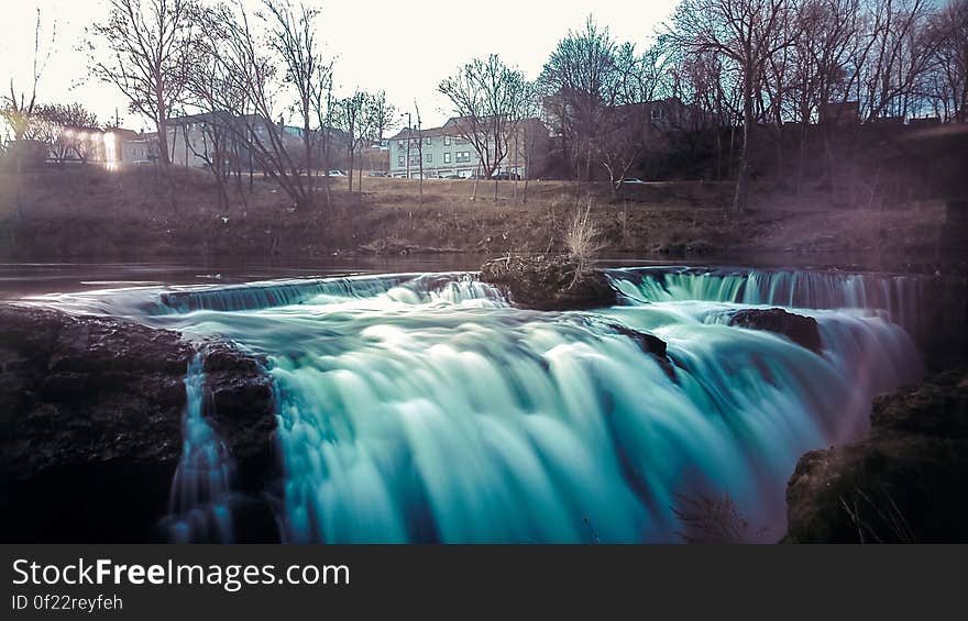 A long exposure of a waterfall cascading down from a small stream. A long exposure of a waterfall cascading down from a small stream.