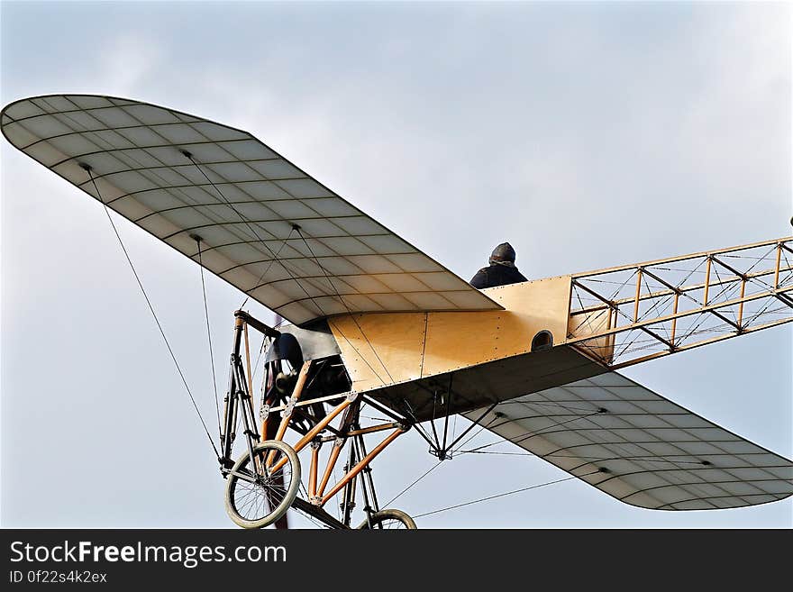 An vintage French Bleriot airplane flying on the sky.