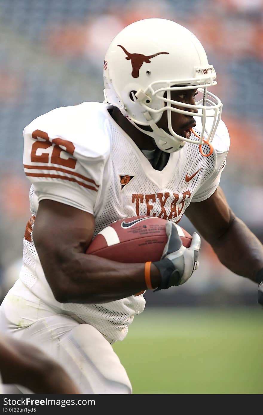 Man Wearing Texas Nike 22 Jersey Holding Ball and Running during Daytime