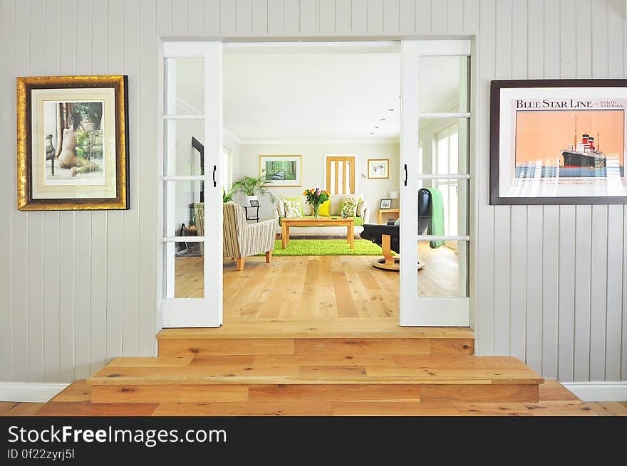 Luxurious modern living room viewed through open French doors. Luxurious modern living room viewed through open French doors.