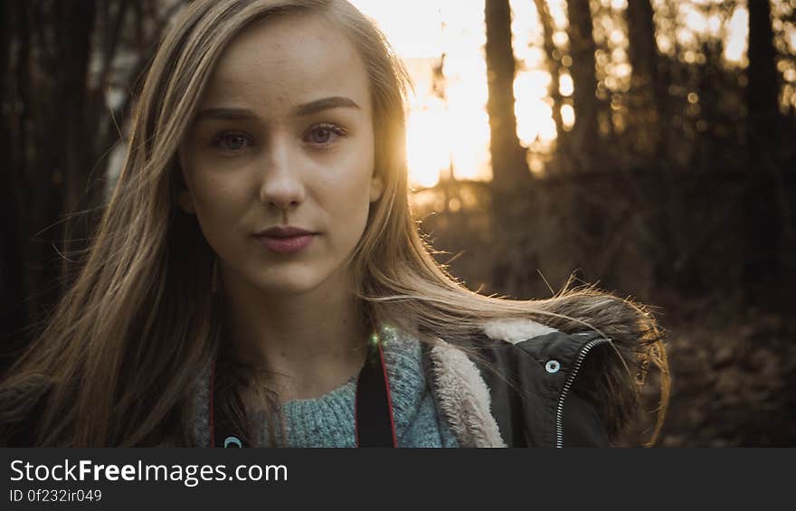 Closeup portrait of attractive young blond girl in a clearing in the forest, background of trees. Closeup portrait of attractive young blond girl in a clearing in the forest, background of trees.