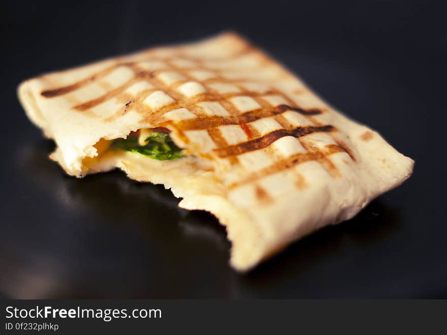 A square wrapped tortilla fried on griddle. A square wrapped tortilla fried on griddle.