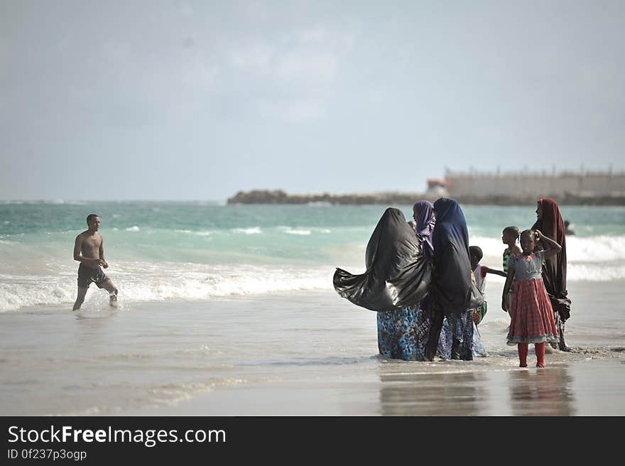 A family stands in the ocean on Lido beach in Mogadishu, Somalia, during Eid al-Fitr on July 28. AMISOM Photo / Tobin Jones. A family stands in the ocean on Lido beach in Mogadishu, Somalia, during Eid al-Fitr on July 28. AMISOM Photo / Tobin Jones