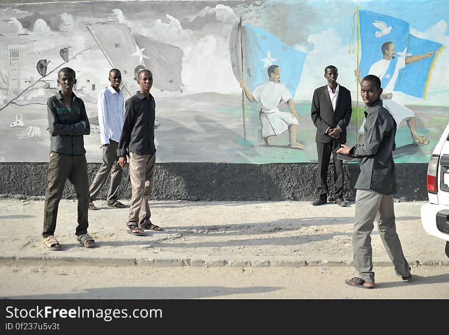 A group of young men take their picture against a mural next to the Tomb of the Unknown Soldier in Mogadishu, Somalia, on July 28. AMISOM Photo / Tobin Jones. A group of young men take their picture against a mural next to the Tomb of the Unknown Soldier in Mogadishu, Somalia, on July 28. AMISOM Photo / Tobin Jones