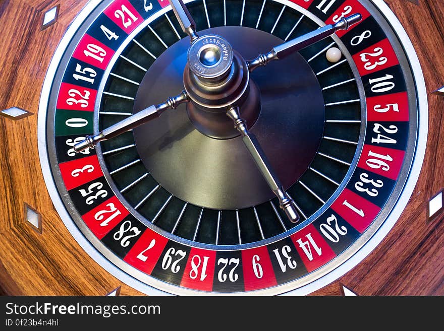 A close up of a roulette wheel in a casino.