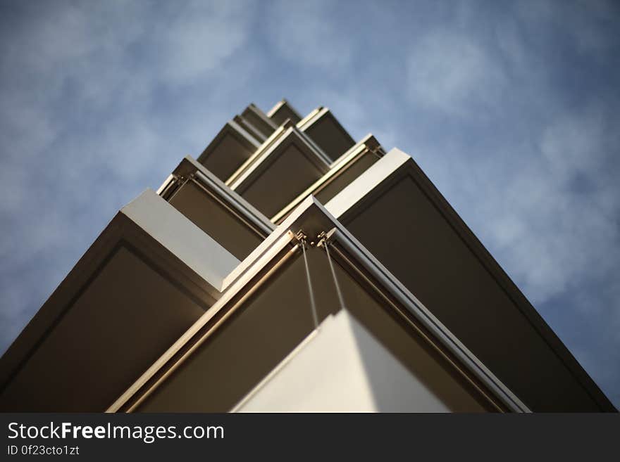 A low angle view of a house corner with balconies against the sky. A low angle view of a house corner with balconies against the sky.